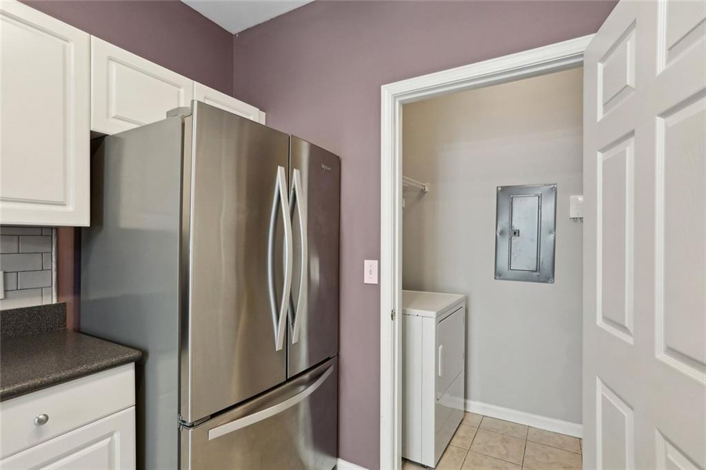 206 Spring Heights Lane, Unit 206 Smyrna, GA 30080 - Photo 15 of 29 a metallic refrigerator freezer sitting in a kitchen