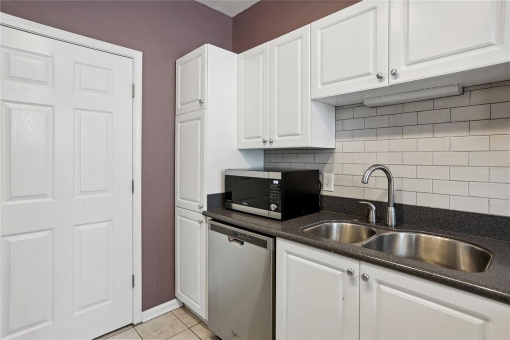 206 Spring Heights Lane, Unit 206 Smyrna, GA 30080 - Photo 16 of 29 a kitchen with stainless steel appliances granite countertop a sink and a white cabinets