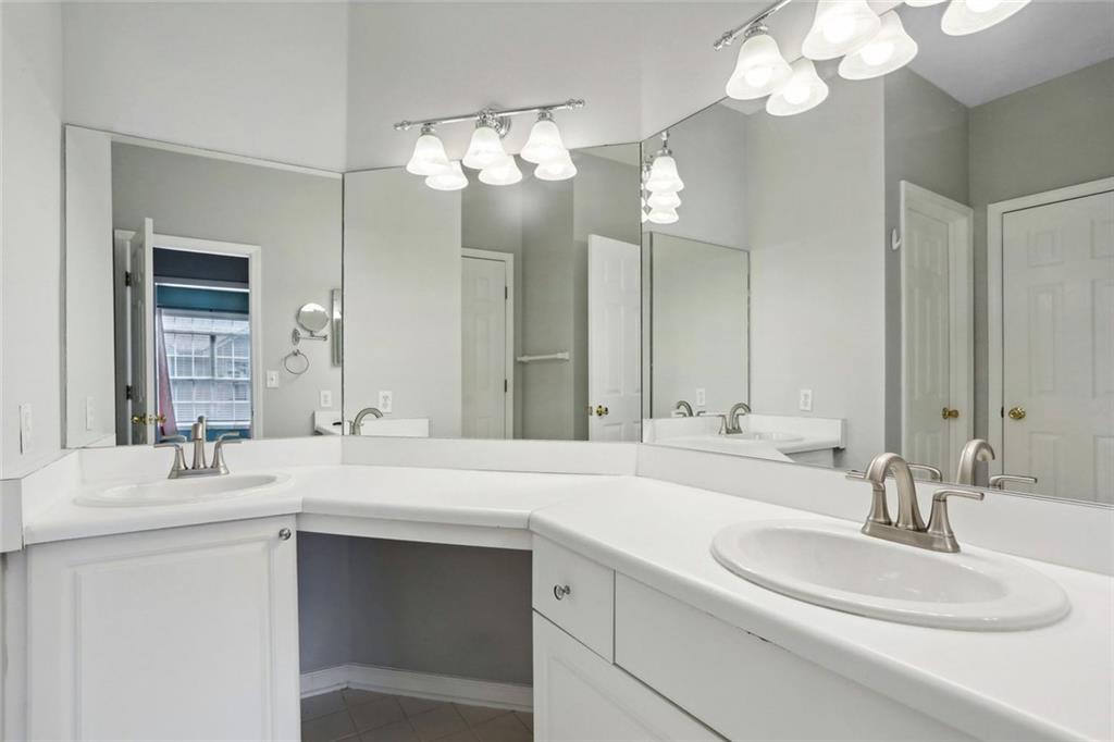 206 Spring Heights Lane, Unit 206 Smyrna, GA 30080 - Photo 23 of 29 a bathroom with a sink double vanity and a mirror