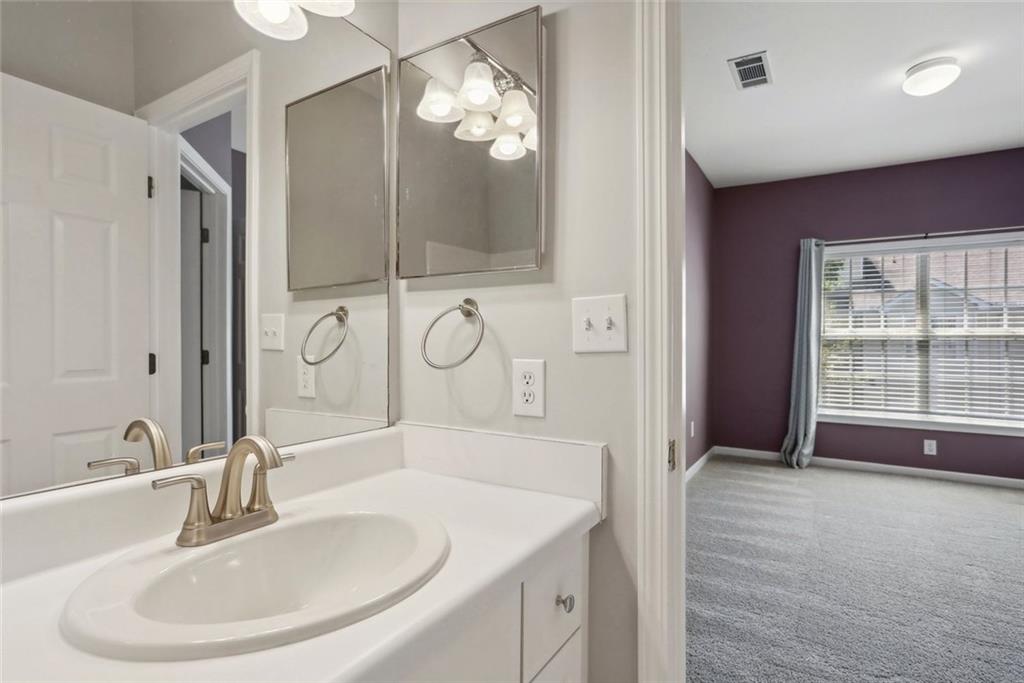 206 Spring Heights Lane, Unit 206 Smyrna, GA 30080 - Photo 27 of 29 a bathroom with a sink and a mirror