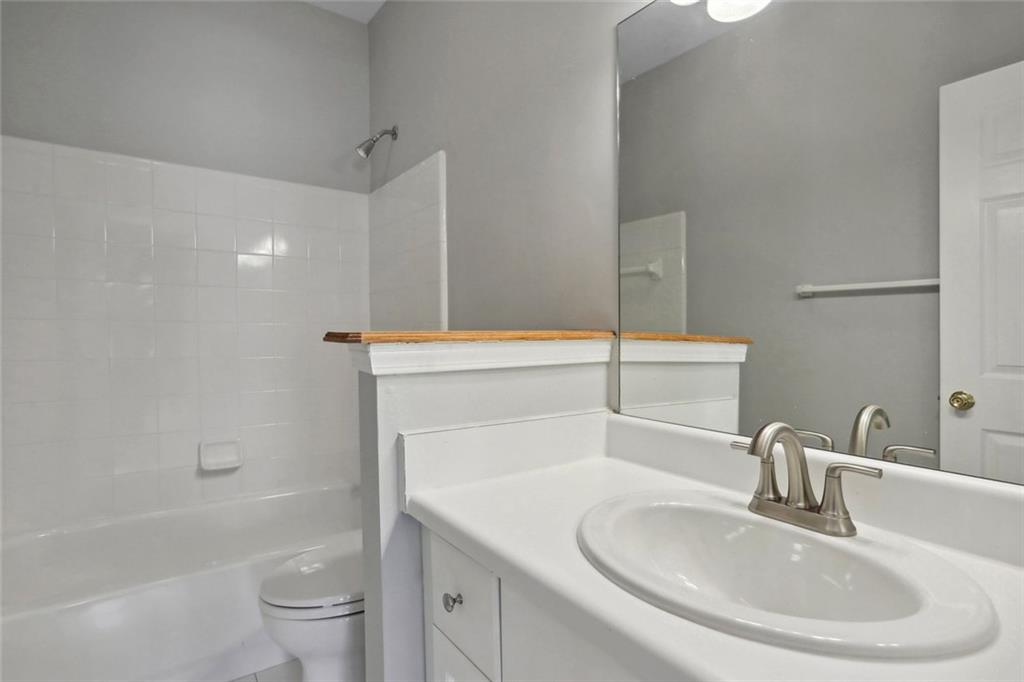 206 Spring Heights Lane, Unit 206 Smyrna, GA 30080 - Photo 28 of 29 a bathroom with a sink a toilet and shower