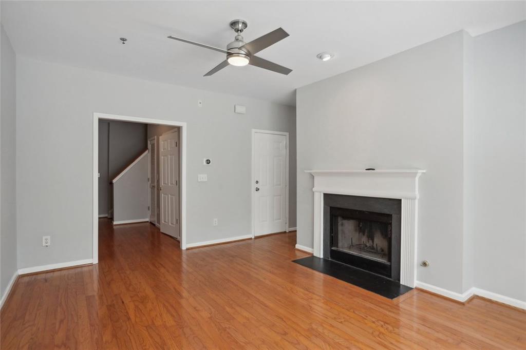 206 Spring Heights Lane, Unit 206 Smyrna, GA 30080 - Photo 9 of 29 a view of an empty room with wooden floor fireplace and a window
