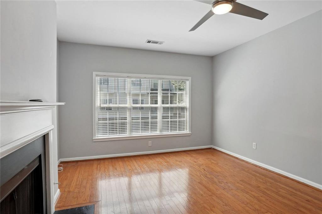 206 Spring Heights Lane, Unit 206 Smyrna, GA 30080 - Photo 10 of 29 an empty room with wooden floor fan and windows