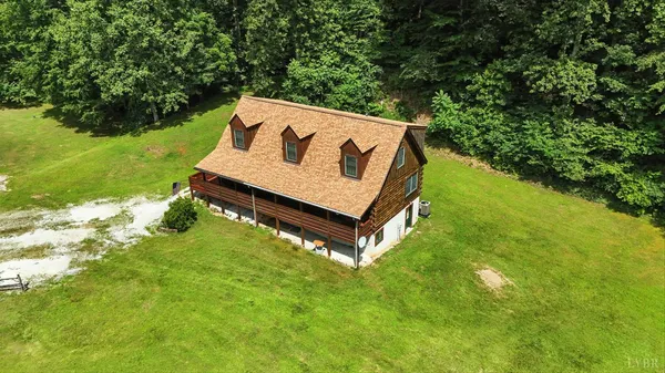 a spacious bedroom with a large bed and a chandelier