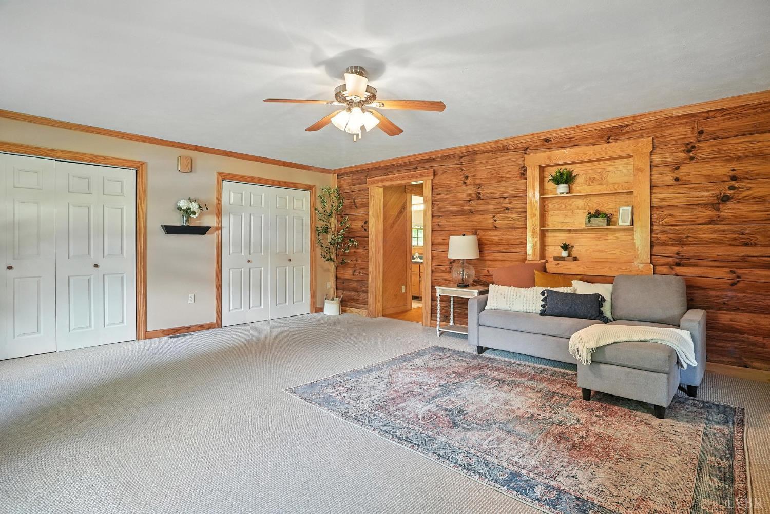2070 Woodson Road Roseland, VA 22967 - Photo 18 of 76 a spacious bedroom with a large bed and a chandelier
