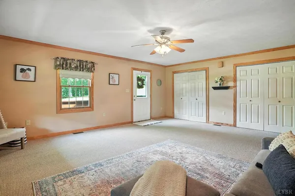 a dining room with wooden floor and windows