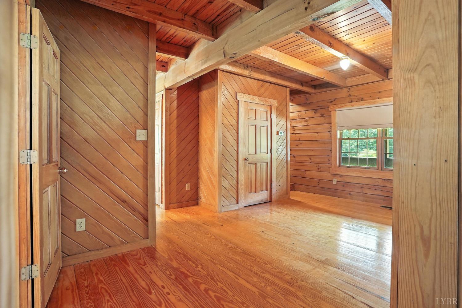 2070 Woodson Road Roseland, VA 22967 - Photo 20 of 76 a view of an empty room with wooden floor and a window