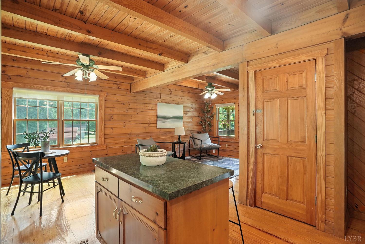 2070 Woodson Road Roseland, VA 22967 - Photo 27 of 76 a kitchen with a table chairs and wooden cabinets