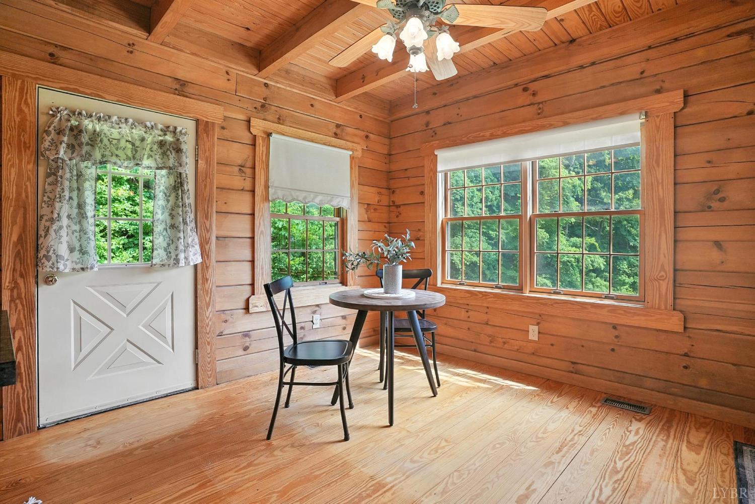 2070 Woodson Road Roseland, VA 22967 - Photo 28 of 76 a dining room with wooden floor and windows