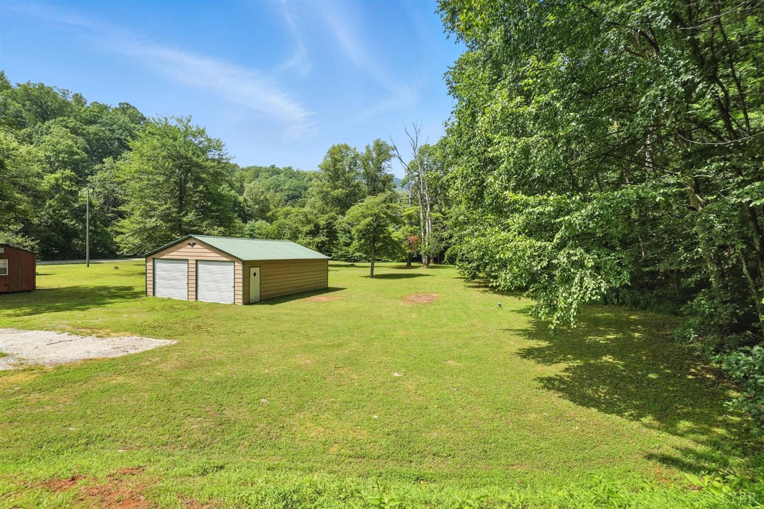 2070 Woodson Road Roseland, VA 22967 - Photo 57 of 76 a front view of a house with a yard and trees