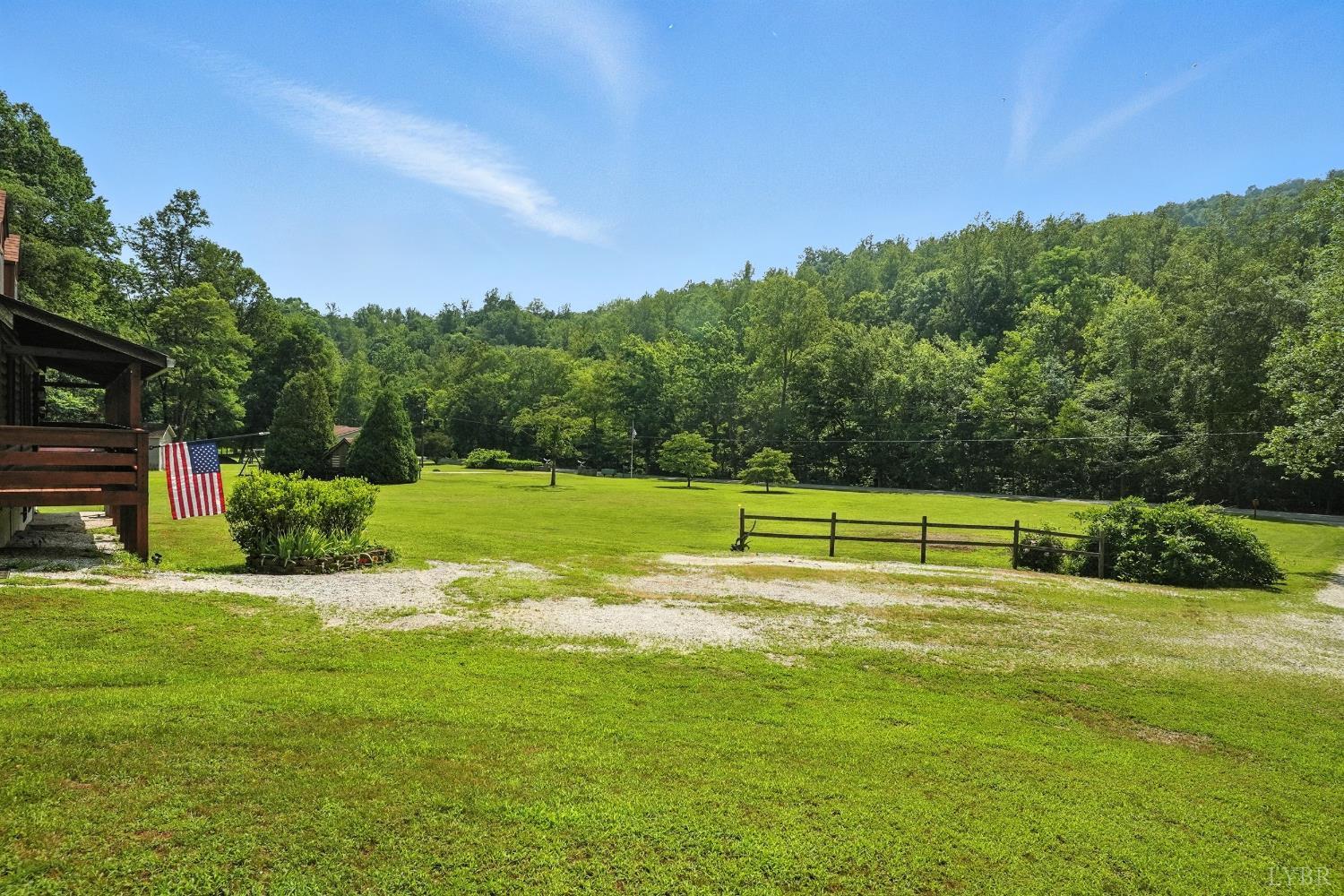 2070 Woodson Road Roseland, VA 22967 - Photo 58 of 76 a view of a golf course with a lake