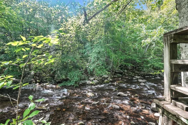 a wooden bench sitting in the middle of a green field