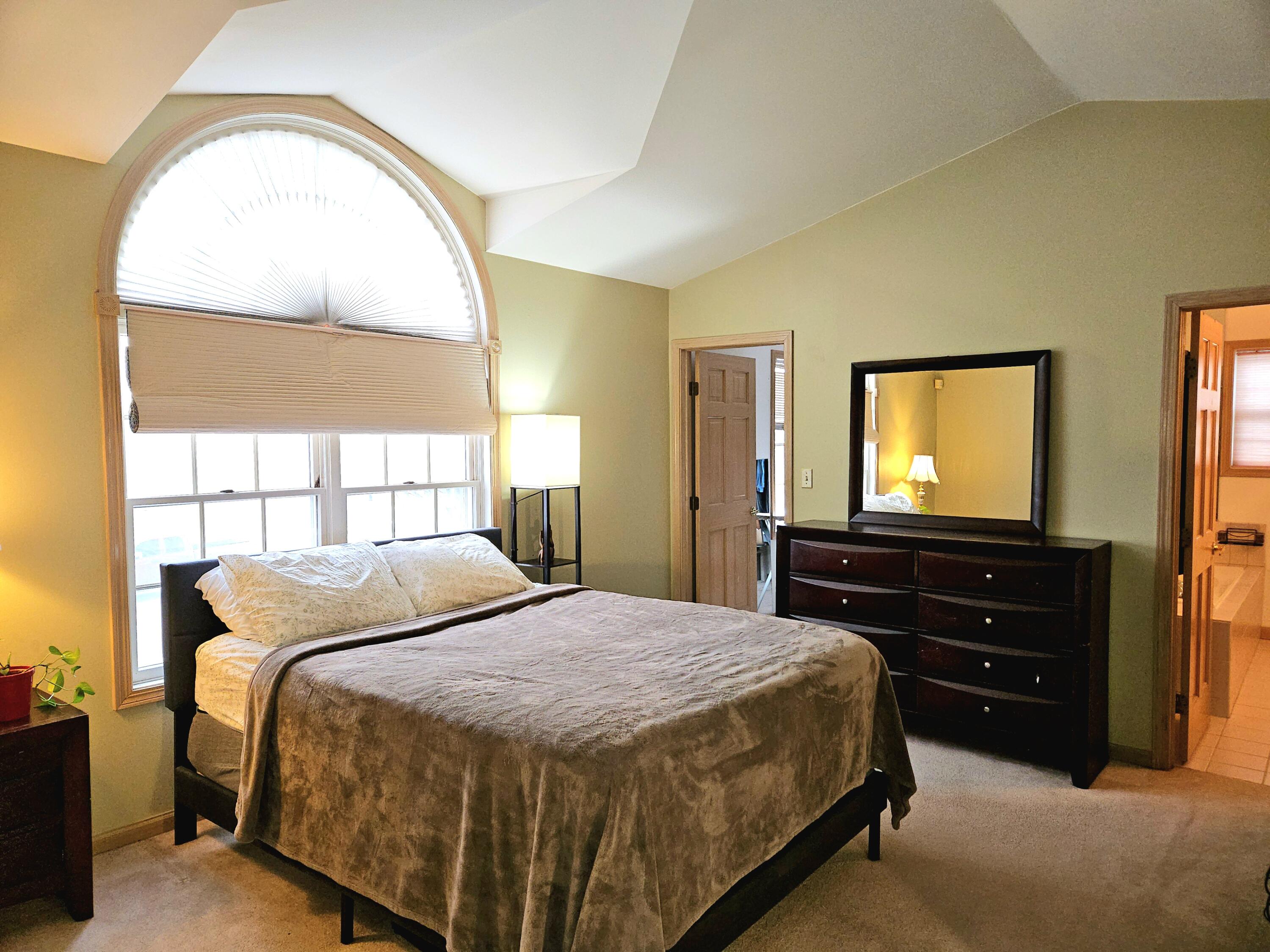 1518 West 96th Place Crown Point, IN 46307 - Photo 14 of 42 a bedroom with a bed and a flat screen tv