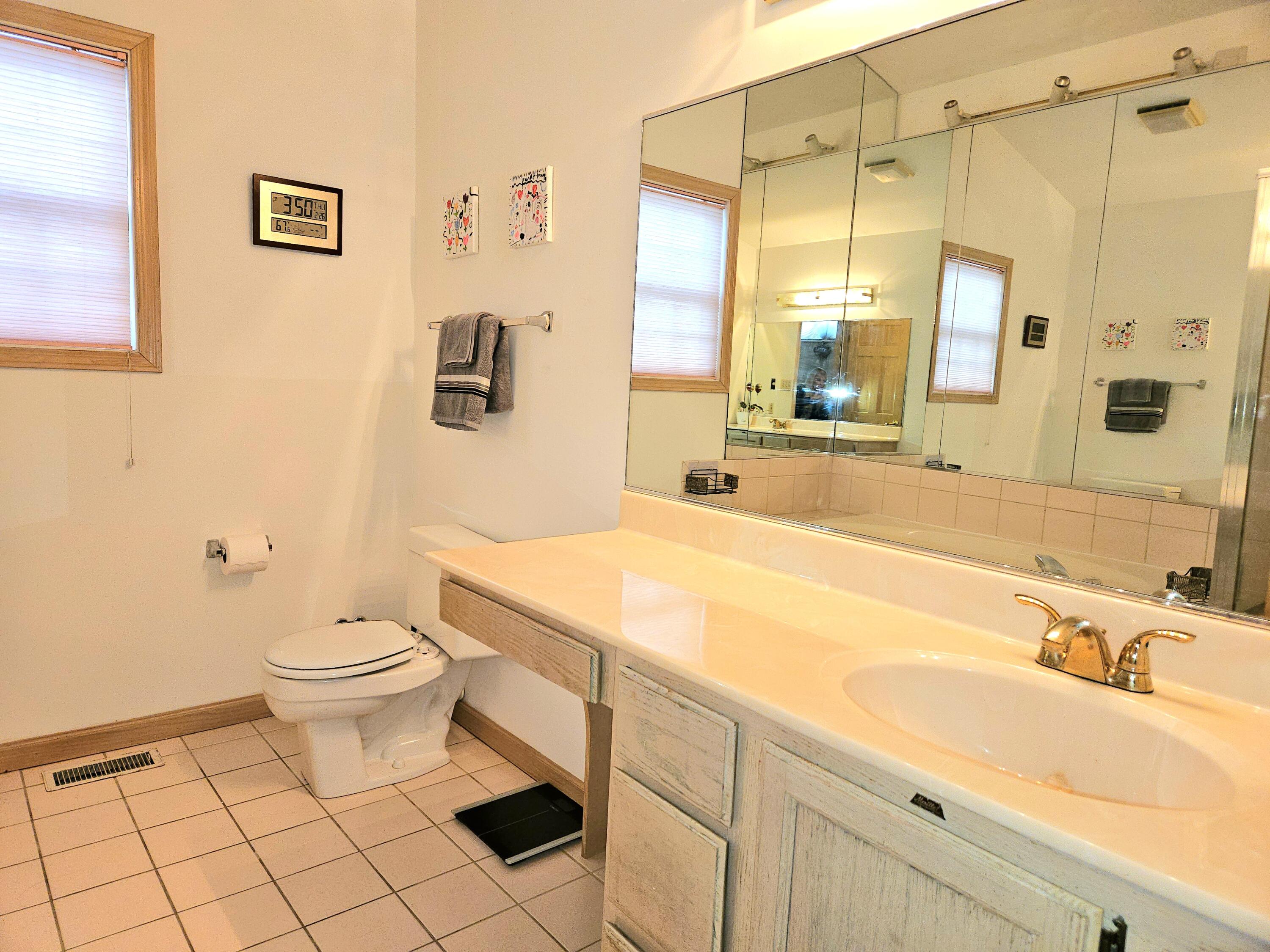 1518 West 96th Place Crown Point, IN 46307 - Photo 16 of 42 a bathroom with a sink a toilet and shower
