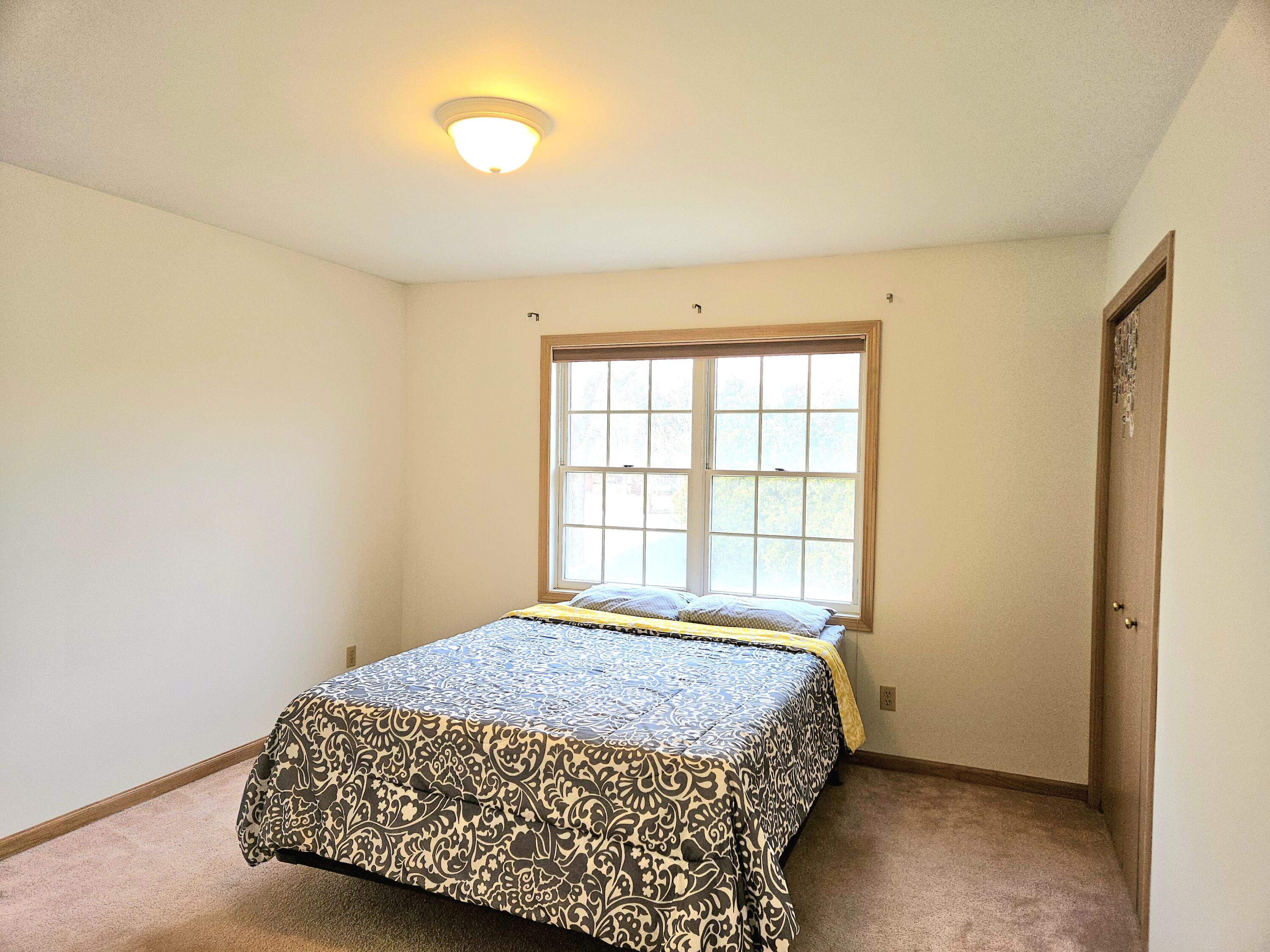 1518 West 96th Place Crown Point, IN 46307 - Photo 19 of 42 a bedroom with a bed and a window