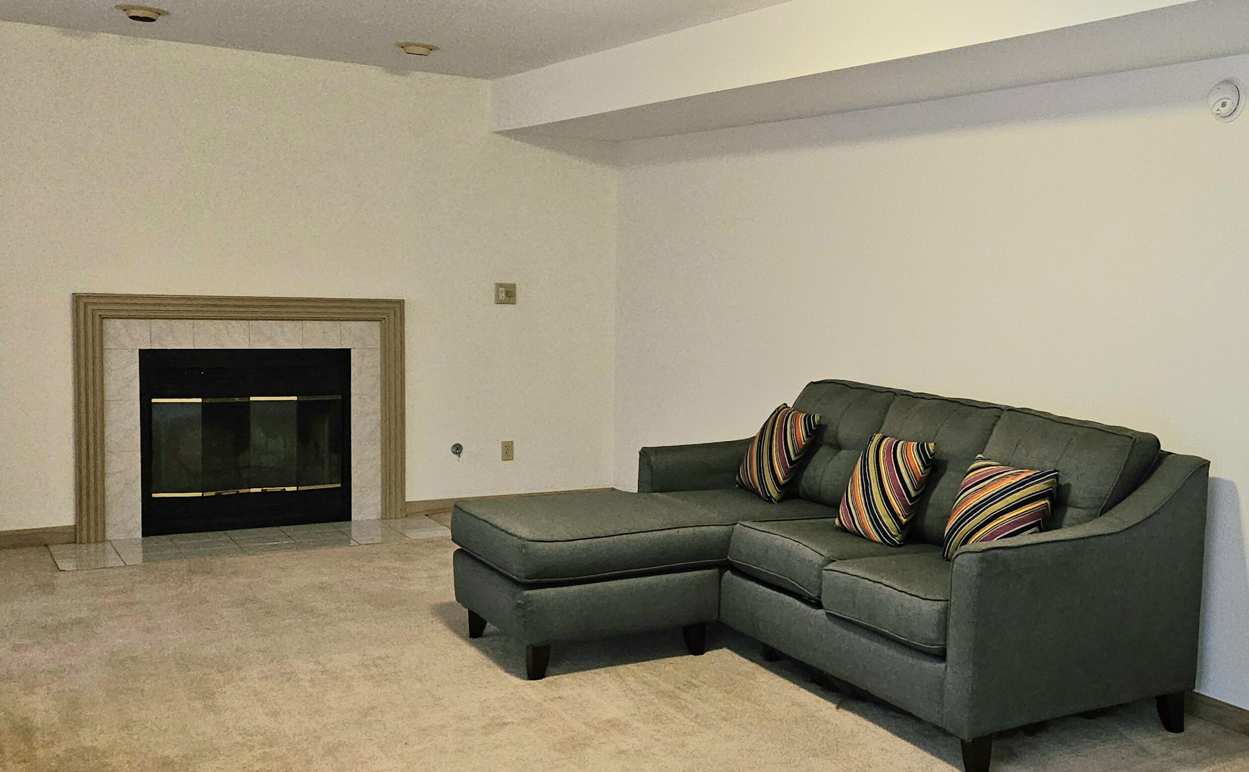 1518 West 96th Place Crown Point, IN 46307 - Photo 24 of 42 a living room with furniture and a fireplace