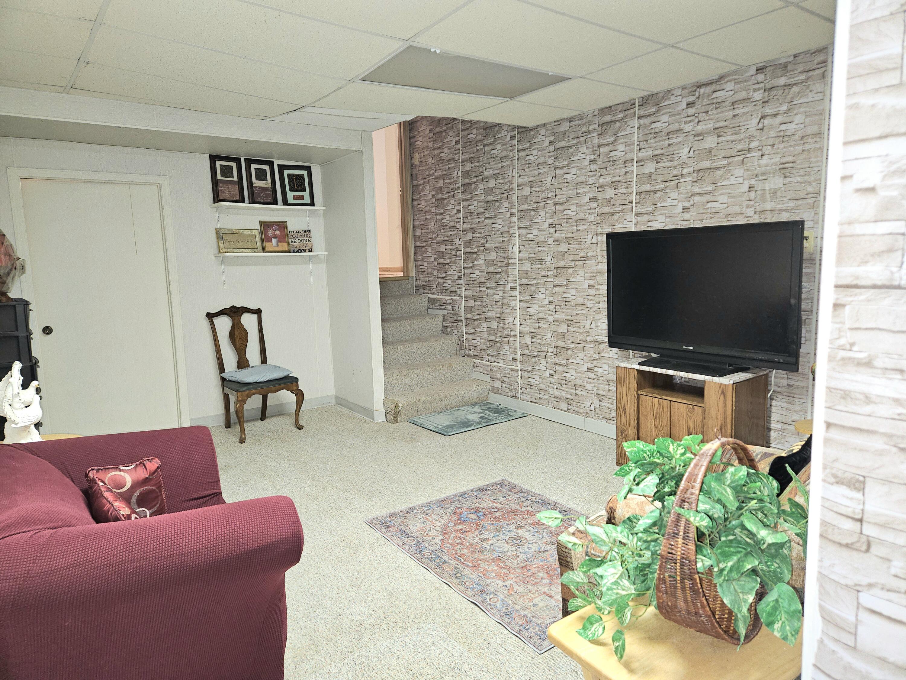 1518 West 96th Place Crown Point, IN 46307 - Photo 28 of 42 a living room with furniture and a flat screen tv