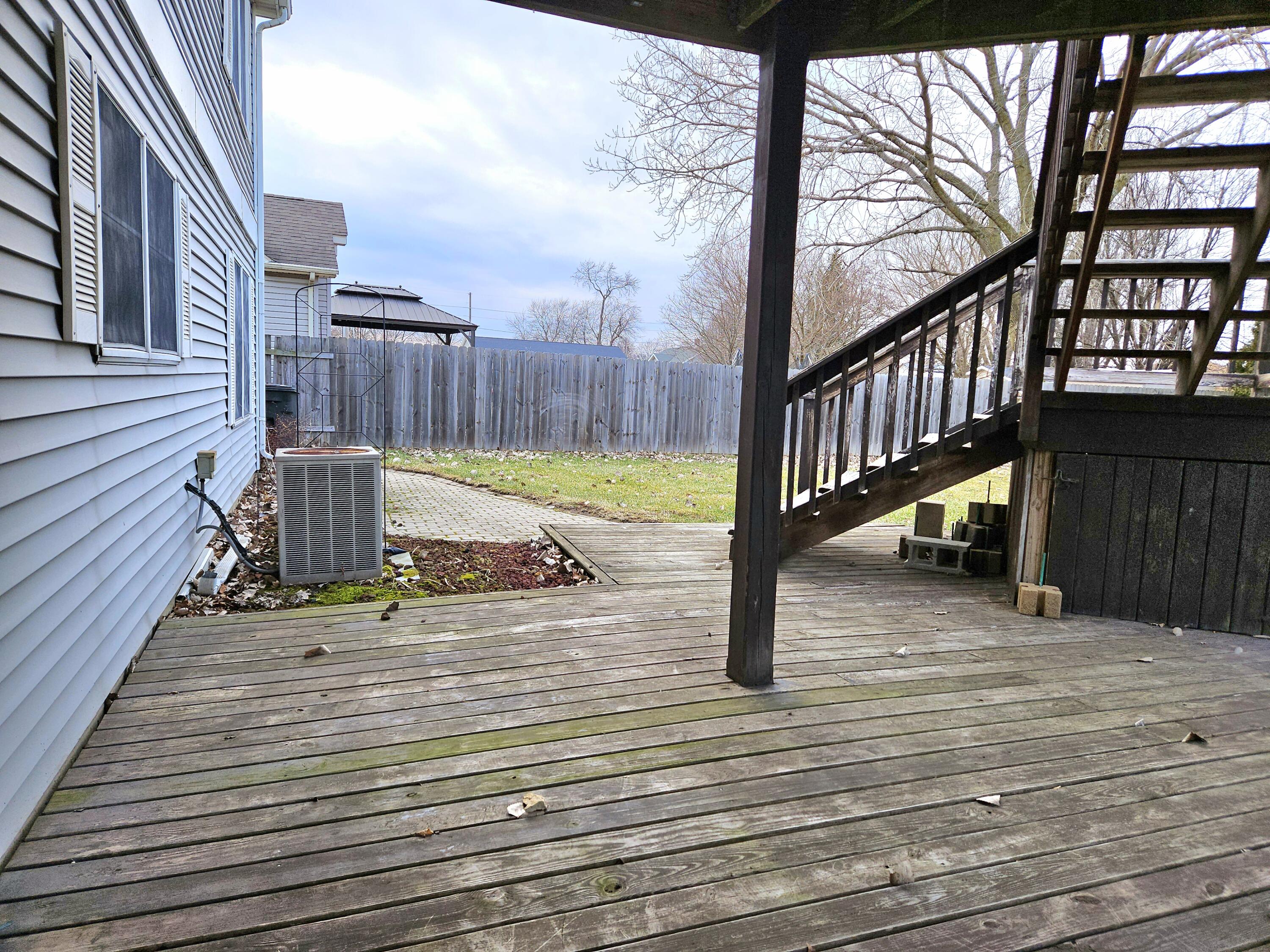 1518 West 96th Place Crown Point, IN 46307 - Photo 36 of 42 a view of a house with wooden deck and furniture