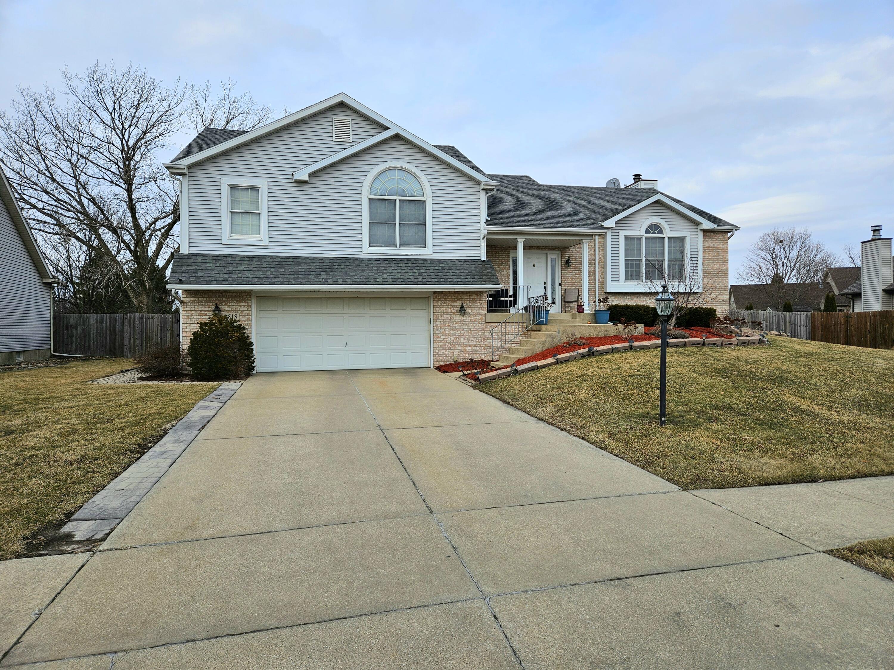 1518 West 96th Place Crown Point, IN 46307 - Photo 39 of 42 a front view of a house with a yard