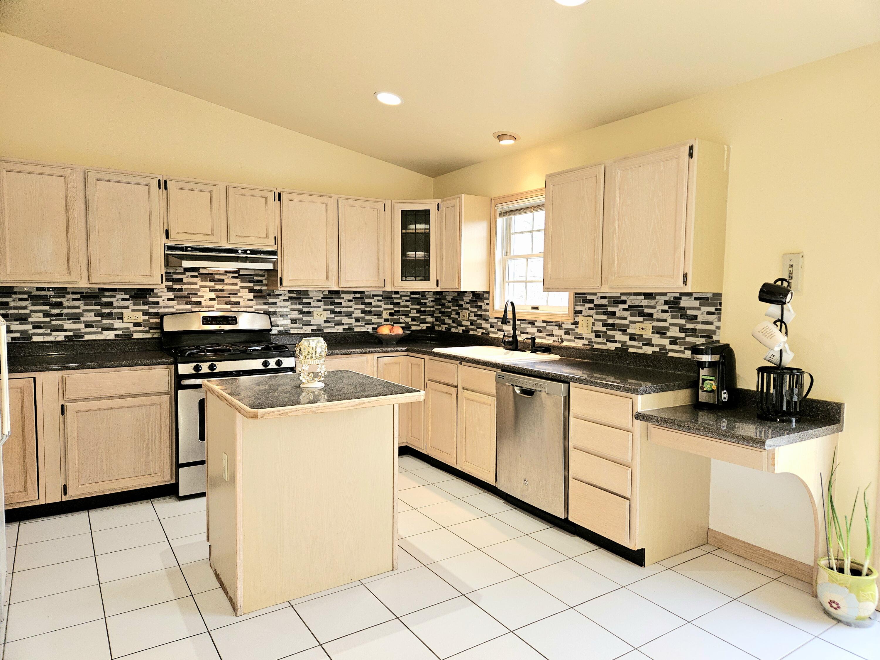 1518 West 96th Place Crown Point, IN 46307 - Photo 4 of 42 a kitchen with white cabinets and appliances
