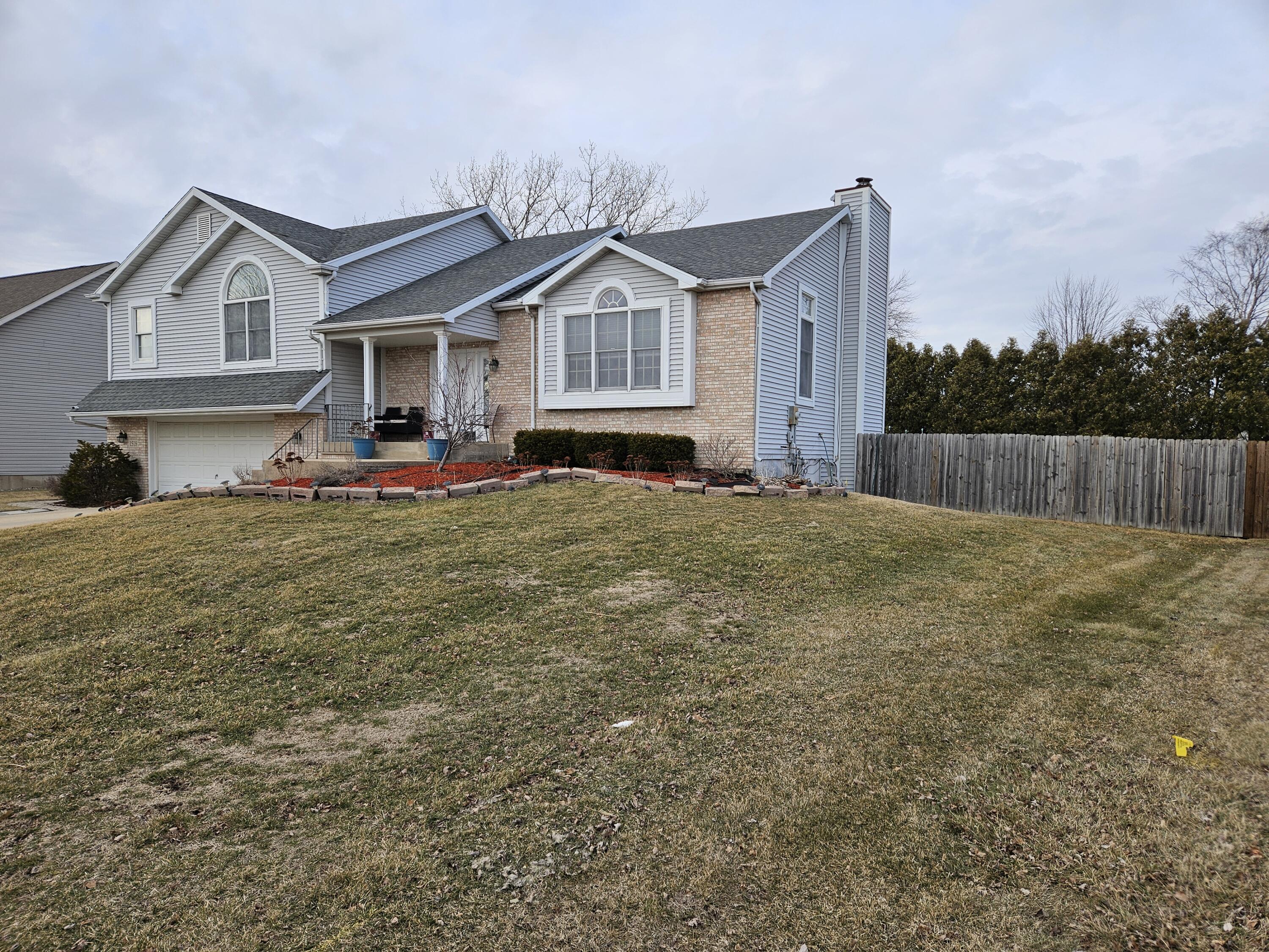 1518 West 96th Place Crown Point, IN 46307 - Photo 42 of 42 a front view of a house with a garden