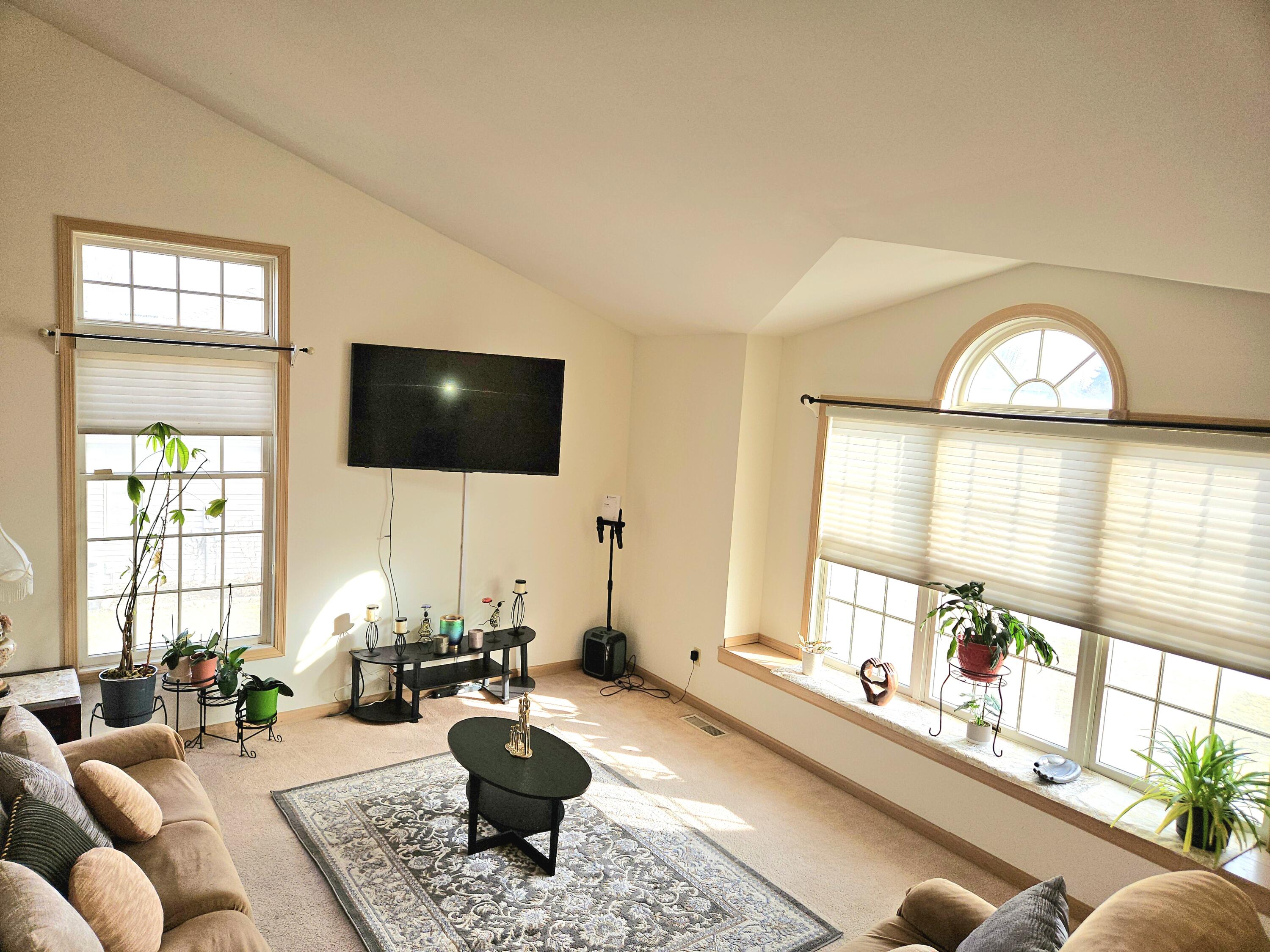 1518 West 96th Place Crown Point, IN 46307 - Photo 5 of 42 a living room with furniture a flat screen tv and a large window