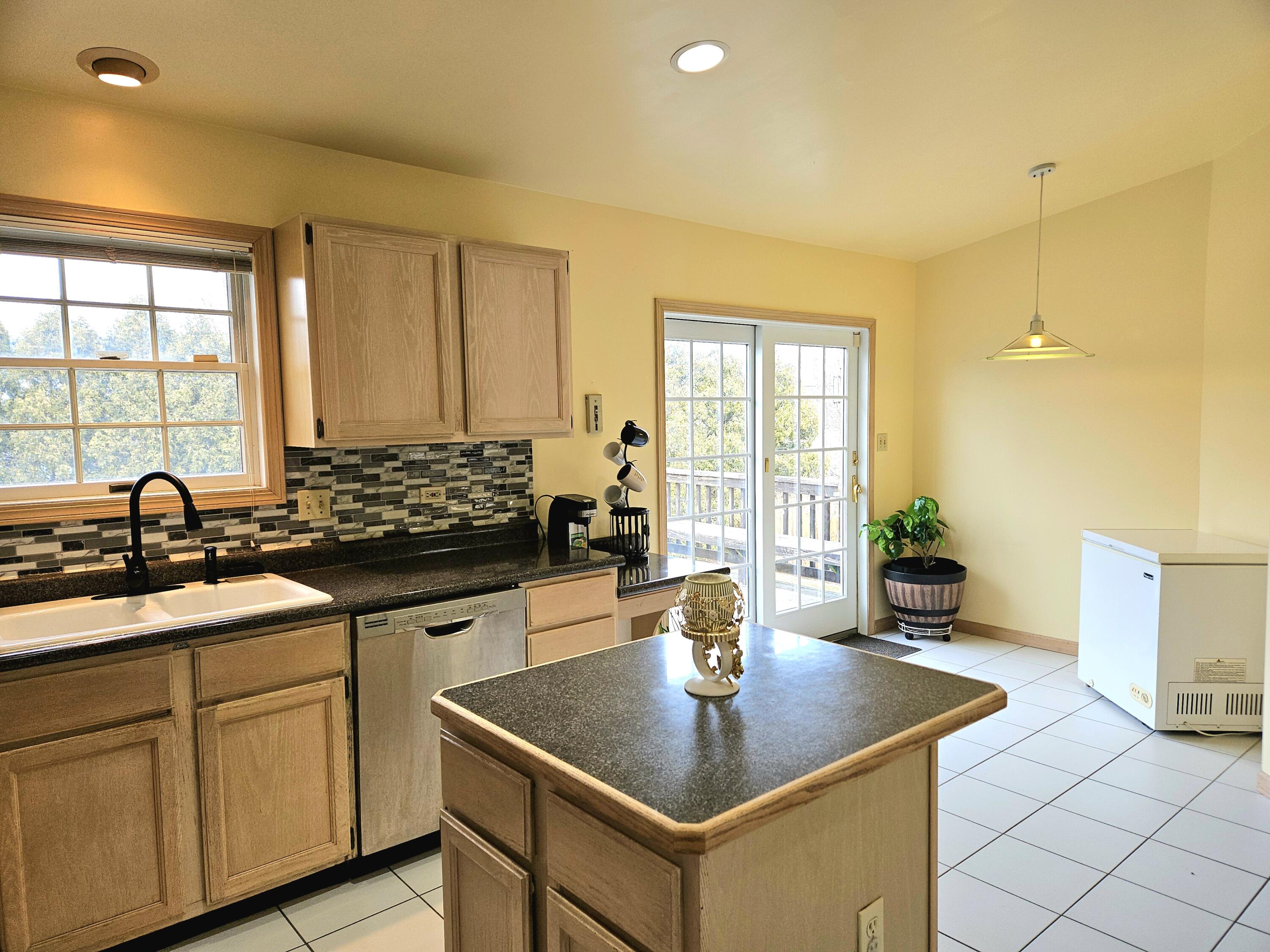1518 West 96th Place Crown Point, IN 46307 - Photo 6 of 42 a kitchen with sink cabinets and living room