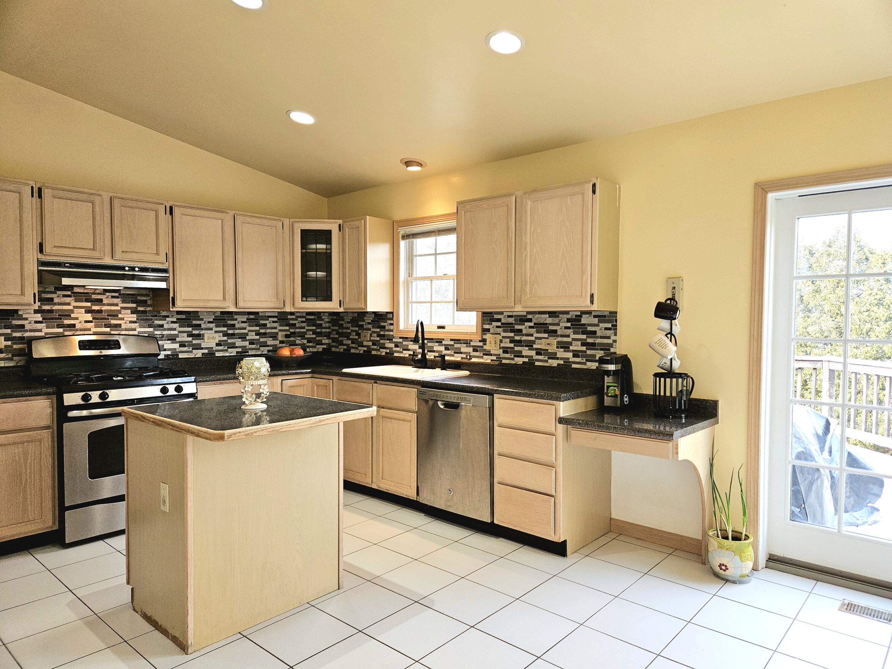 1518 West 96th Place Crown Point, IN 46307 - Photo 7 of 42 a kitchen with white cabinets and appliances