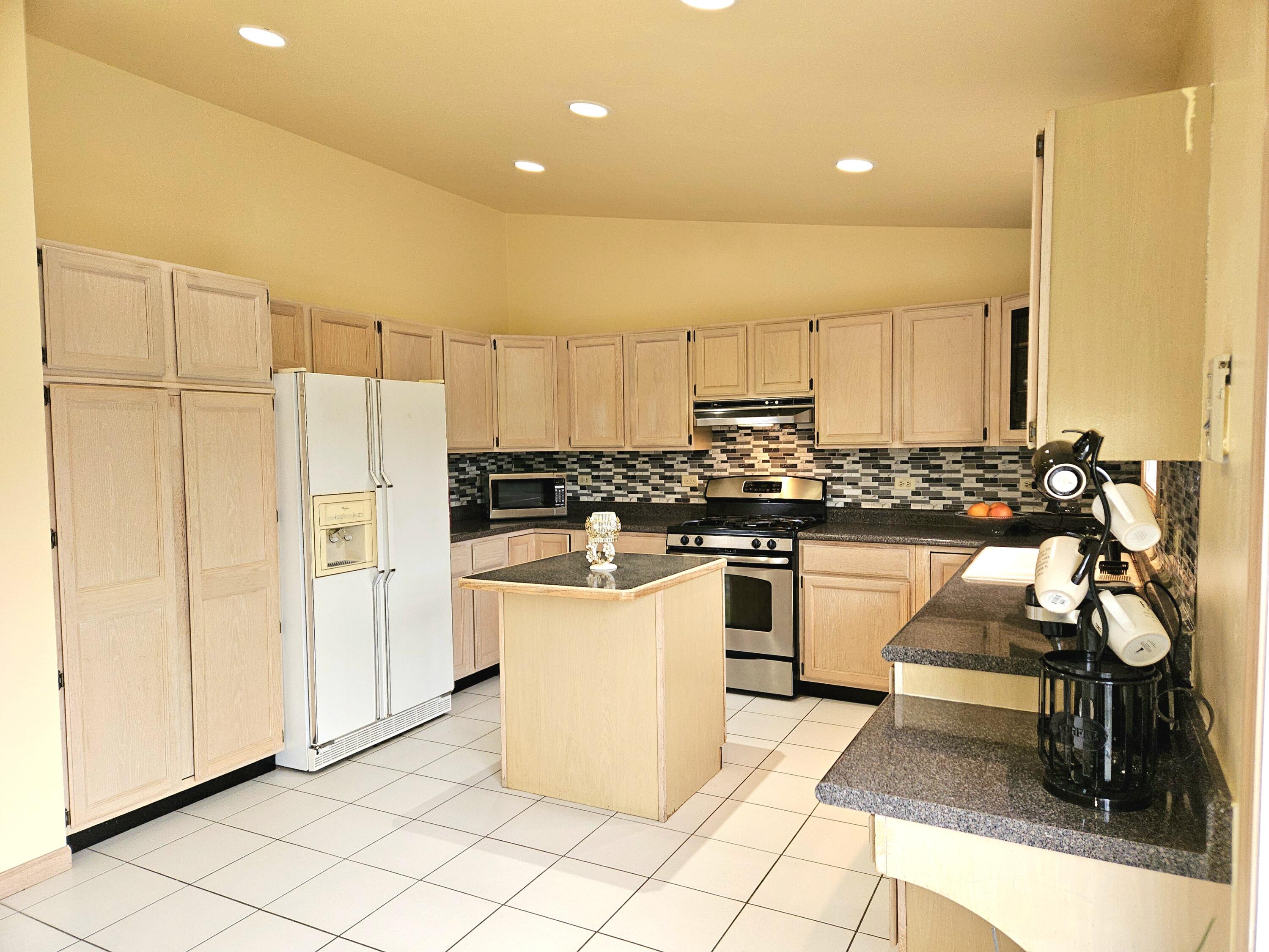 1518 West 96th Place Crown Point, IN 46307 - Photo 8 of 42 a kitchen with stainless steel appliances kitchen island granite countertop a sink and white cabinets