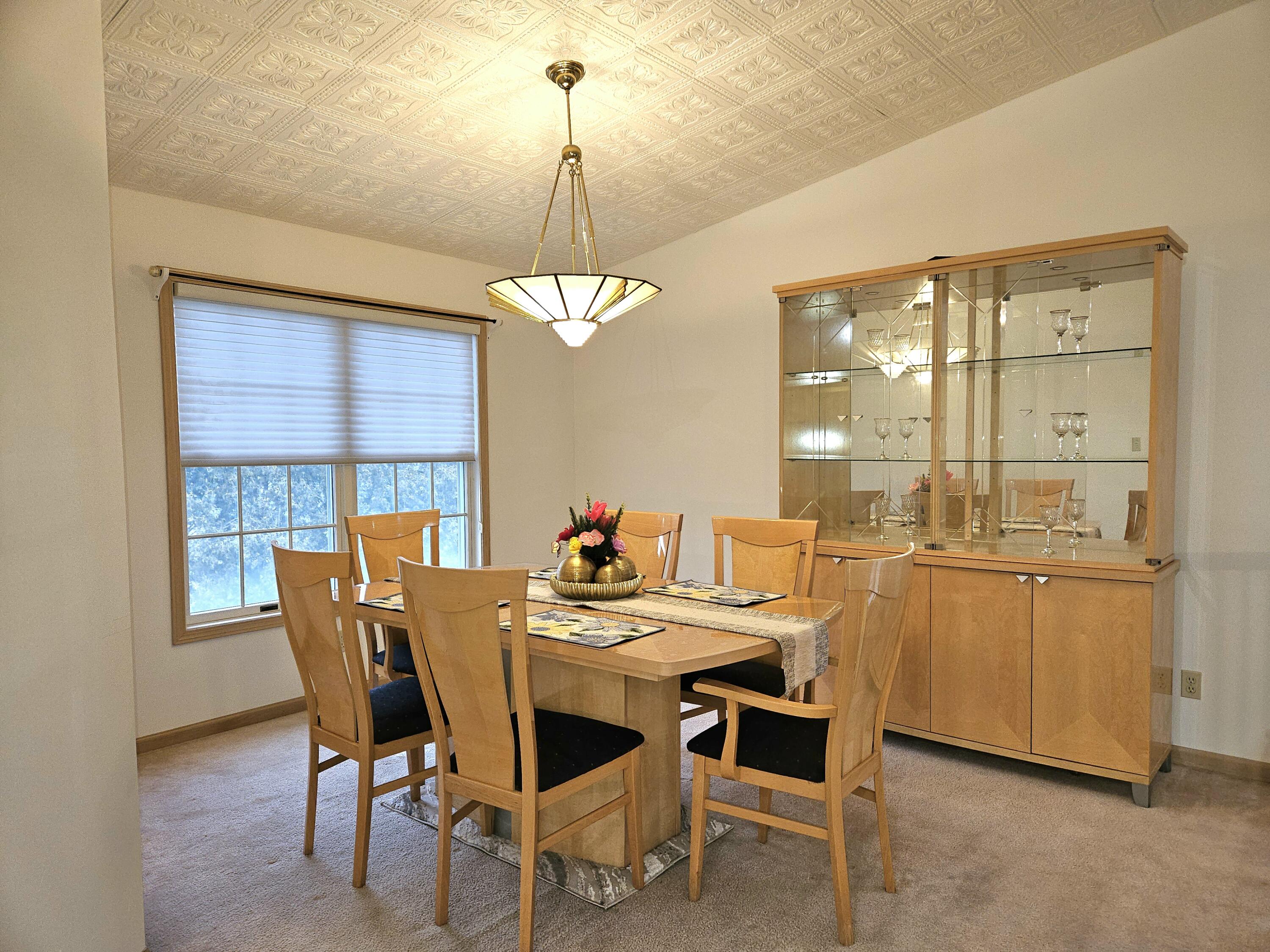 1518 West 96th Place Crown Point, IN 46307 - Photo 10 of 42 a view of a dining room with furniture wooden floor and chandelier