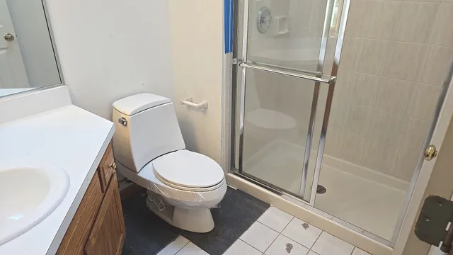a white toilet sitting next to a bath tub