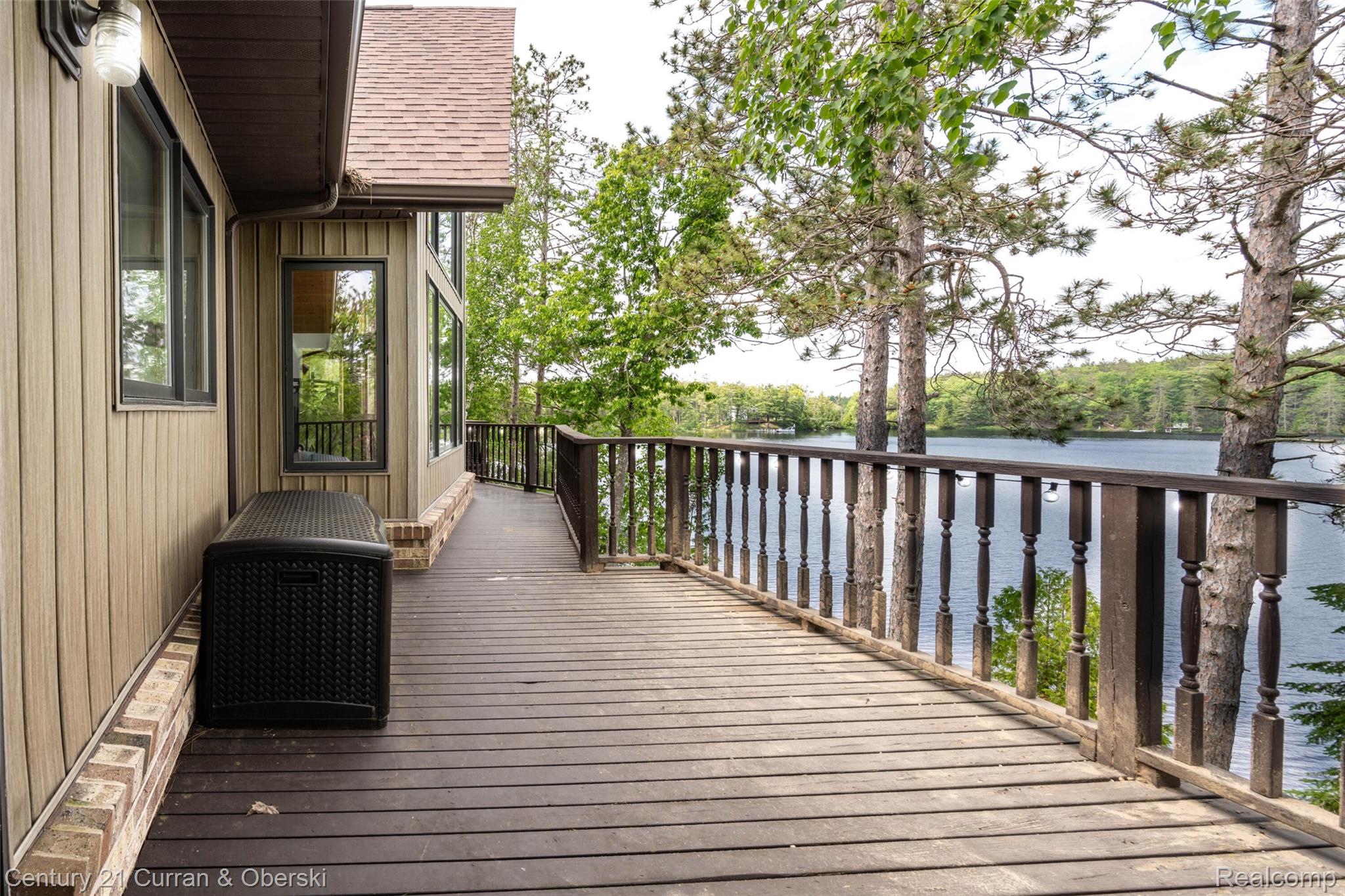 8775 Winding Rdg Drive Millersburg, MI 49759 - Photo 35 of 53 Expansive outdoor deck featuring dark wood-finish decking and a classic spindle railing