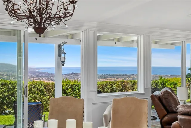a view of a balcony with chairs and a potted plant