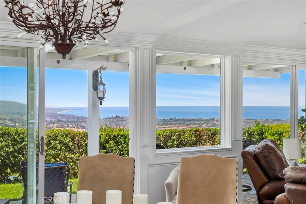 a view of a balcony with chairs and a potted plant