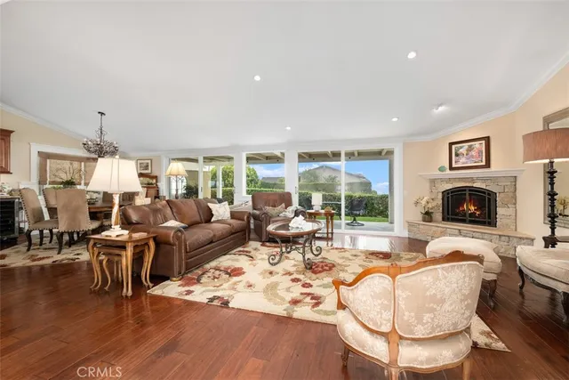 a living room with fireplace furniture and a large window