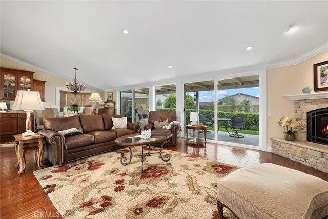 a living room with furniture large window and a table