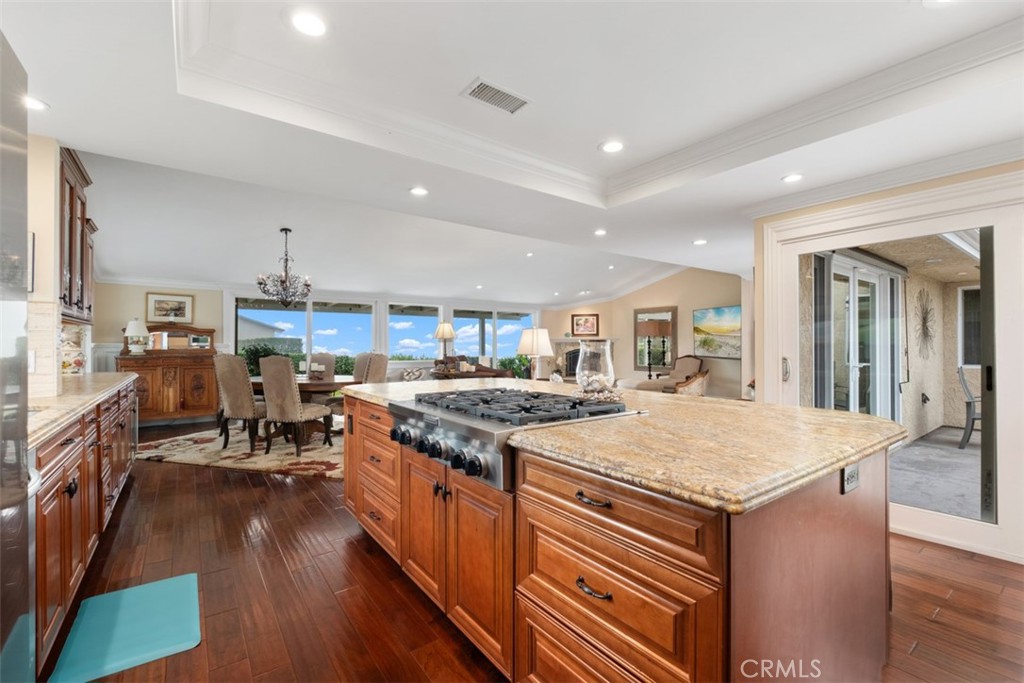 31202 Palma Drive Laguna Niguel, CA 92677 - Photo 21 of 47 a kitchen with stainless steel appliances granite countertop a stove oven a sink dishwasher and a dining table with wooden floor
