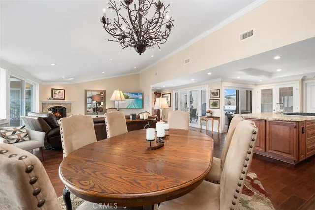 a dining room with furniture and wooden floor