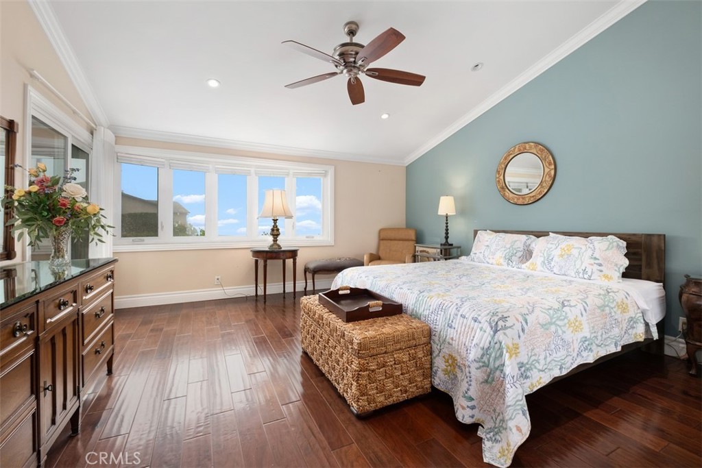 31202 Palma Drive Laguna Niguel, CA 92677 - Photo 26 of 47 a bedroom with a bed and a chandelier