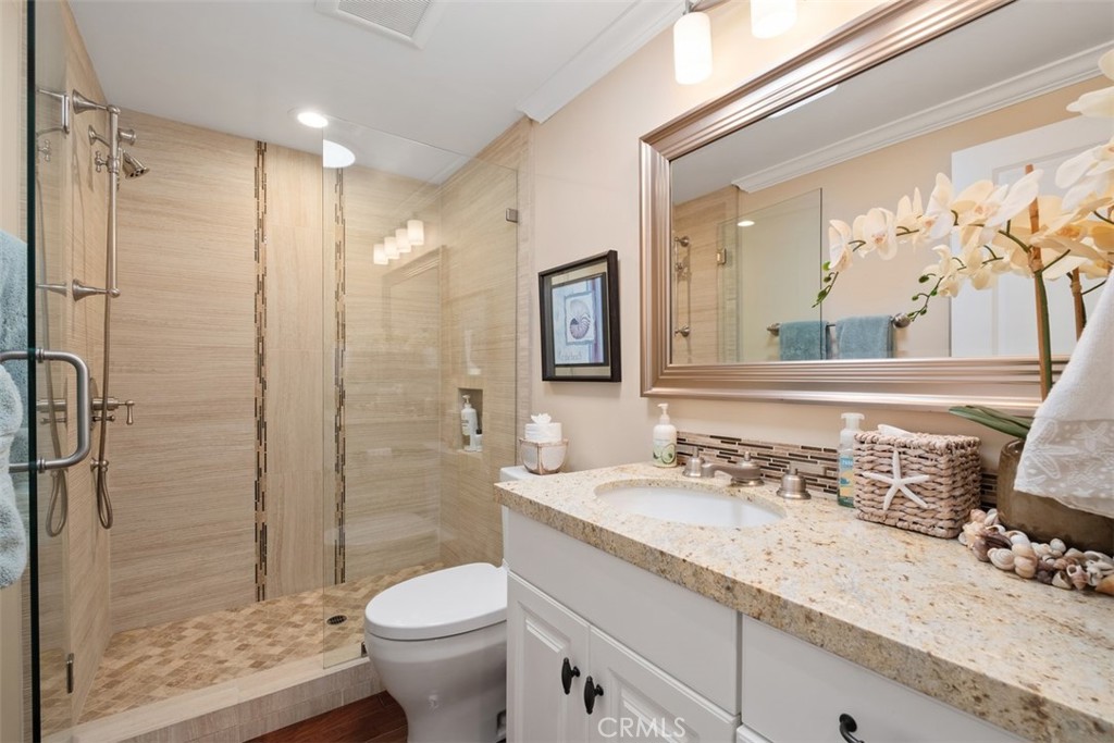 31202 Palma Drive Laguna Niguel, CA 92677 - Photo 32 of 47 a bathroom with a granite countertop sink toilet and shower