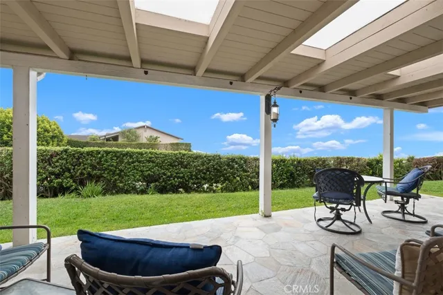 a view of a patio with a table chairs and a backyard