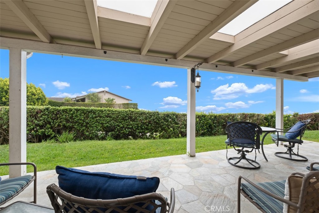 31202 Palma Drive Laguna Niguel, CA 92677 - Photo 33 of 47 a view of a patio with a table chairs and a backyard