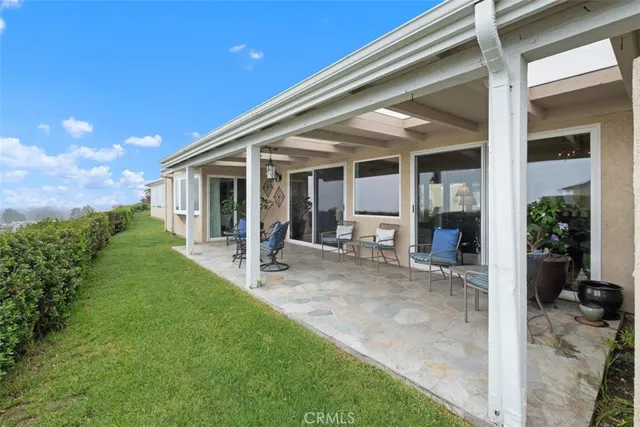 a view of a house with backyard and porch