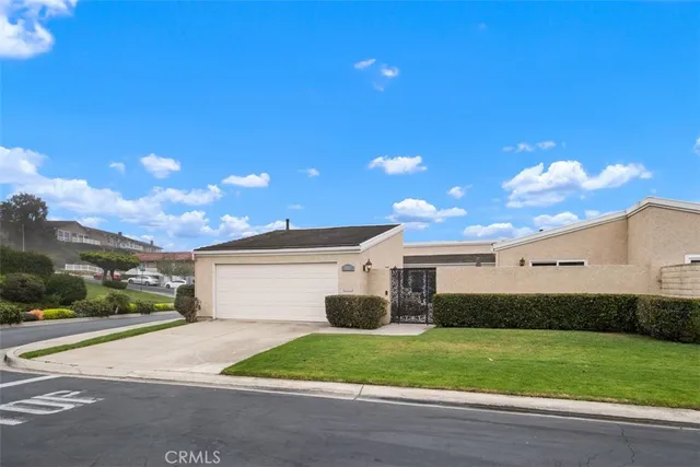 a view of a house with a yard and garage