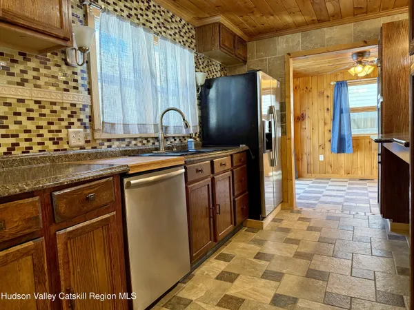 a kitchen with stainless steel appliances granite countertop a refrigerator and a sink