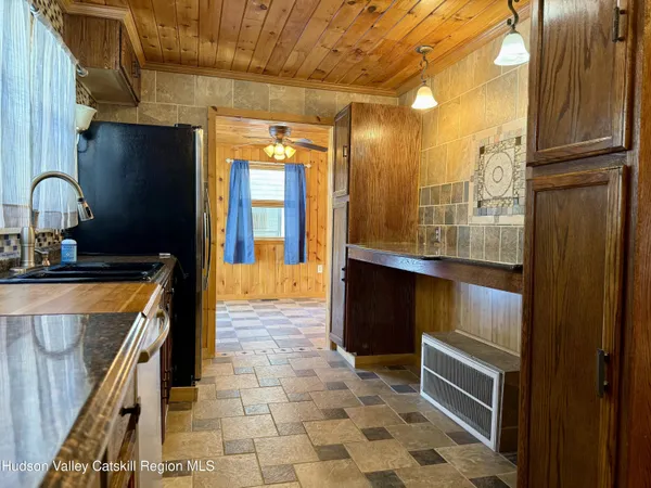a kitchen with a sink and a refrigerator