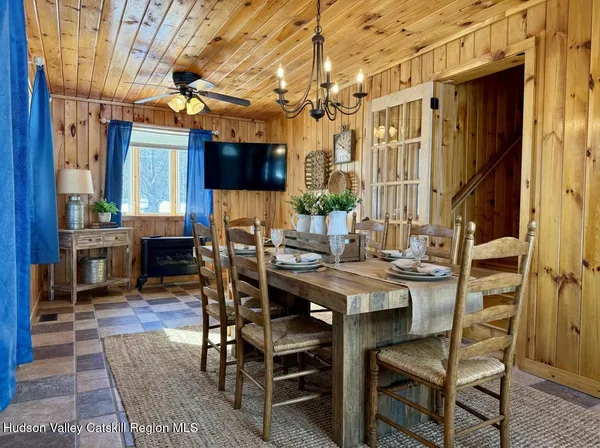 a view of a dining room with furniture and chandelier