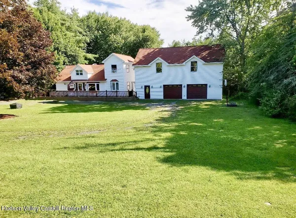 a aerial view of a house with a big yard and large trees