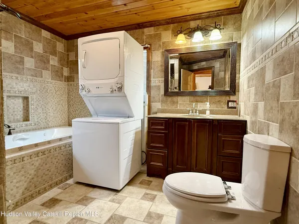 a bathroom with a sink a toilet and mirror