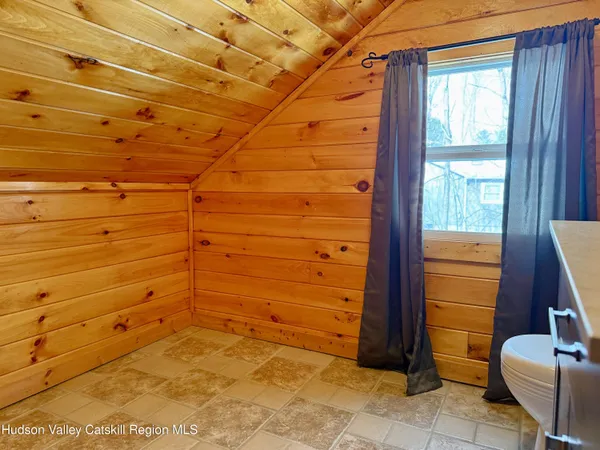 a bathroom with a toilet and a window